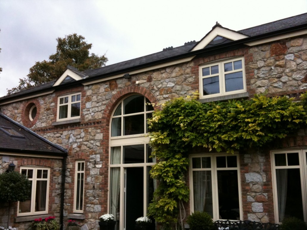 stone house with black gutters
